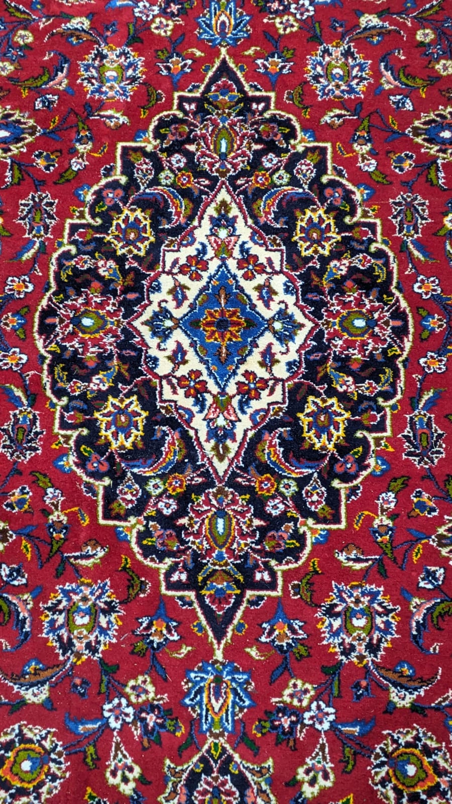 A Tabriz burgundy ground carpet, 292 x 216cm